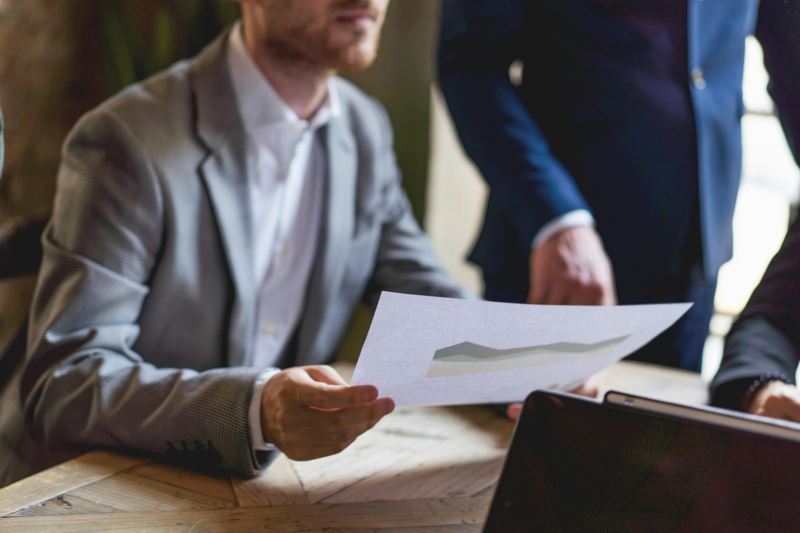 Business Consultation - cropped businessman with a financial document