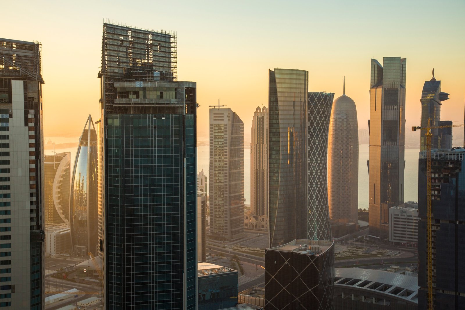 Cityscape with tall modern skyscrapers at dusk.